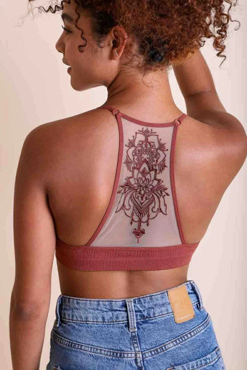 Woman showcasing a tattoo on her back wearing a Tattoo Mesh Racerback Bralette