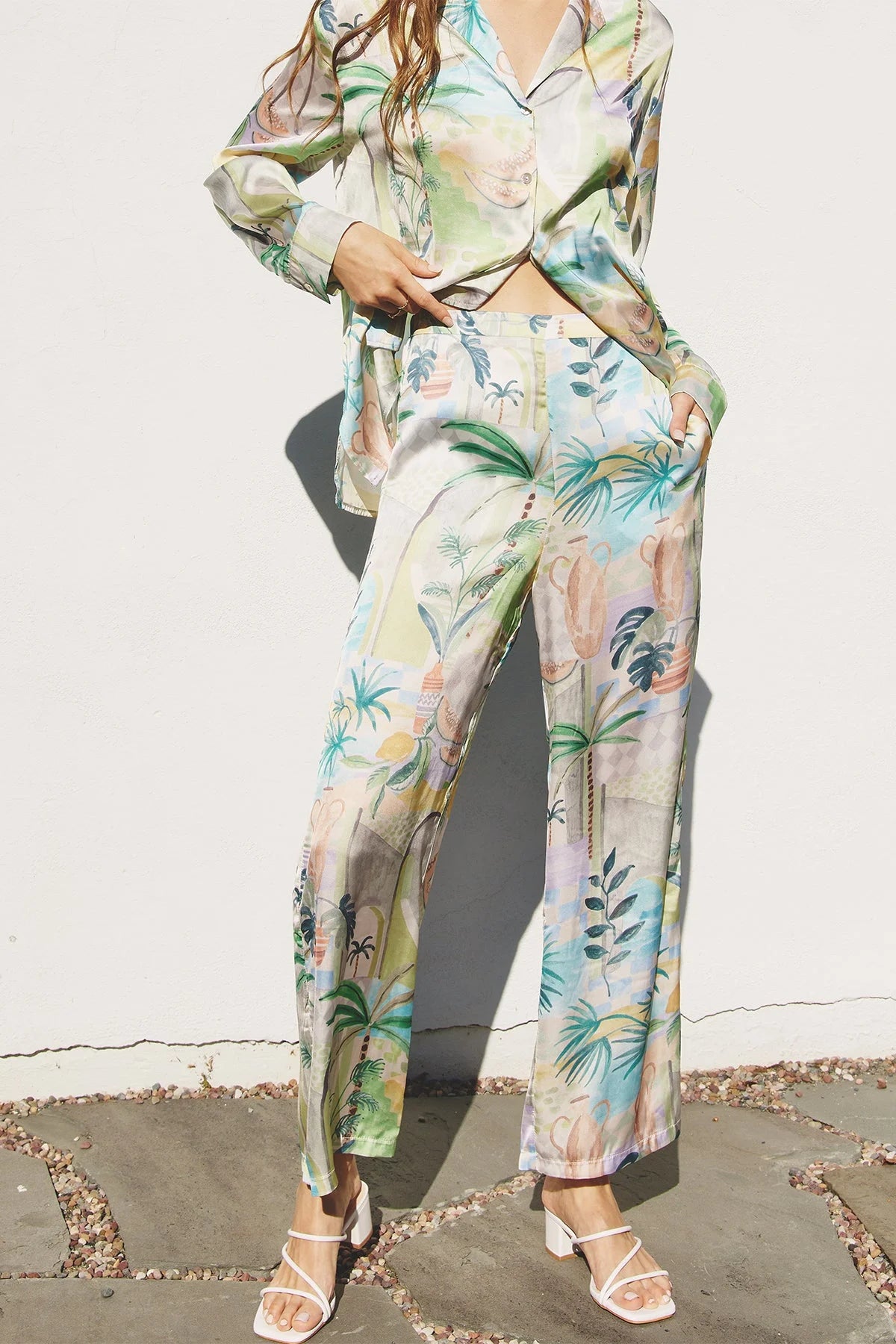 Woman in a tropical print boho shirt and pants set, perfect for out of office style