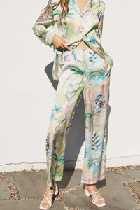 Woman in a tropical print boho shirt and pants set, perfect for out of office style