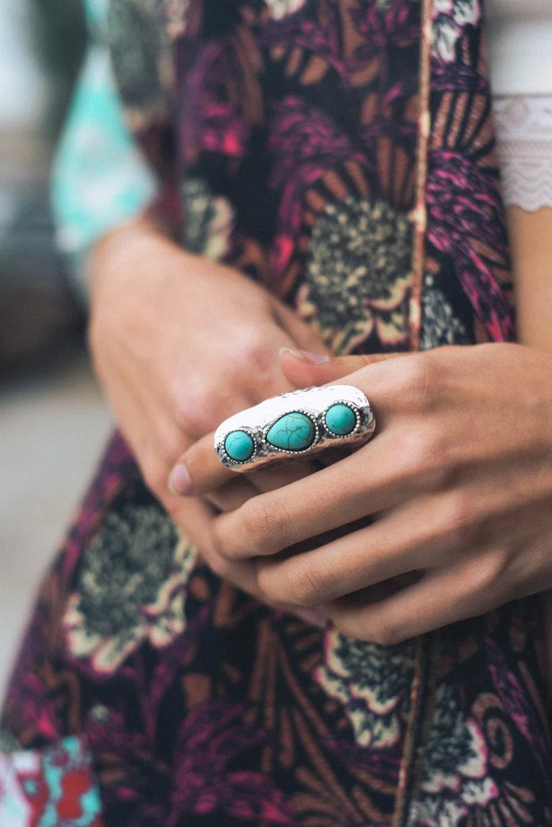 Woman showcasing the TURQUOISE WATERFALL DROPLET ADJUSTABLE RING with a vibrant turquoise stone