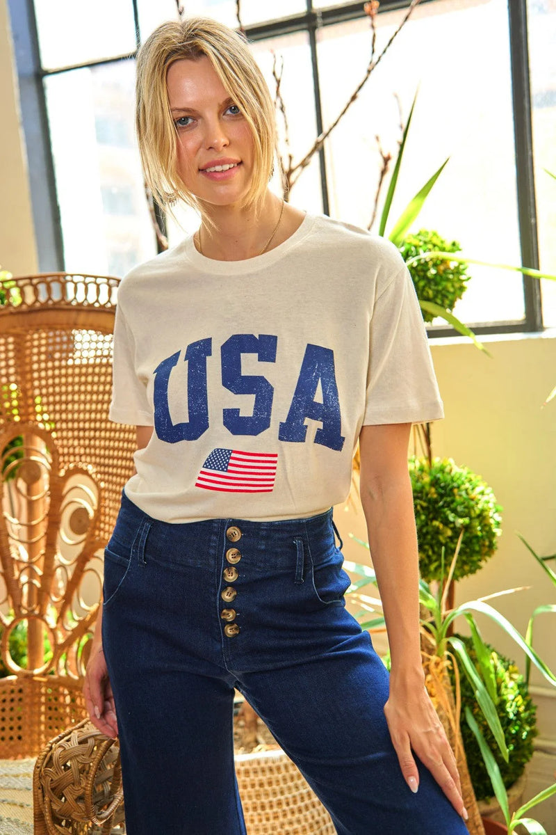 A woman in a USA graphic print short sleeve t-shirt and jeans, showcasing boho style