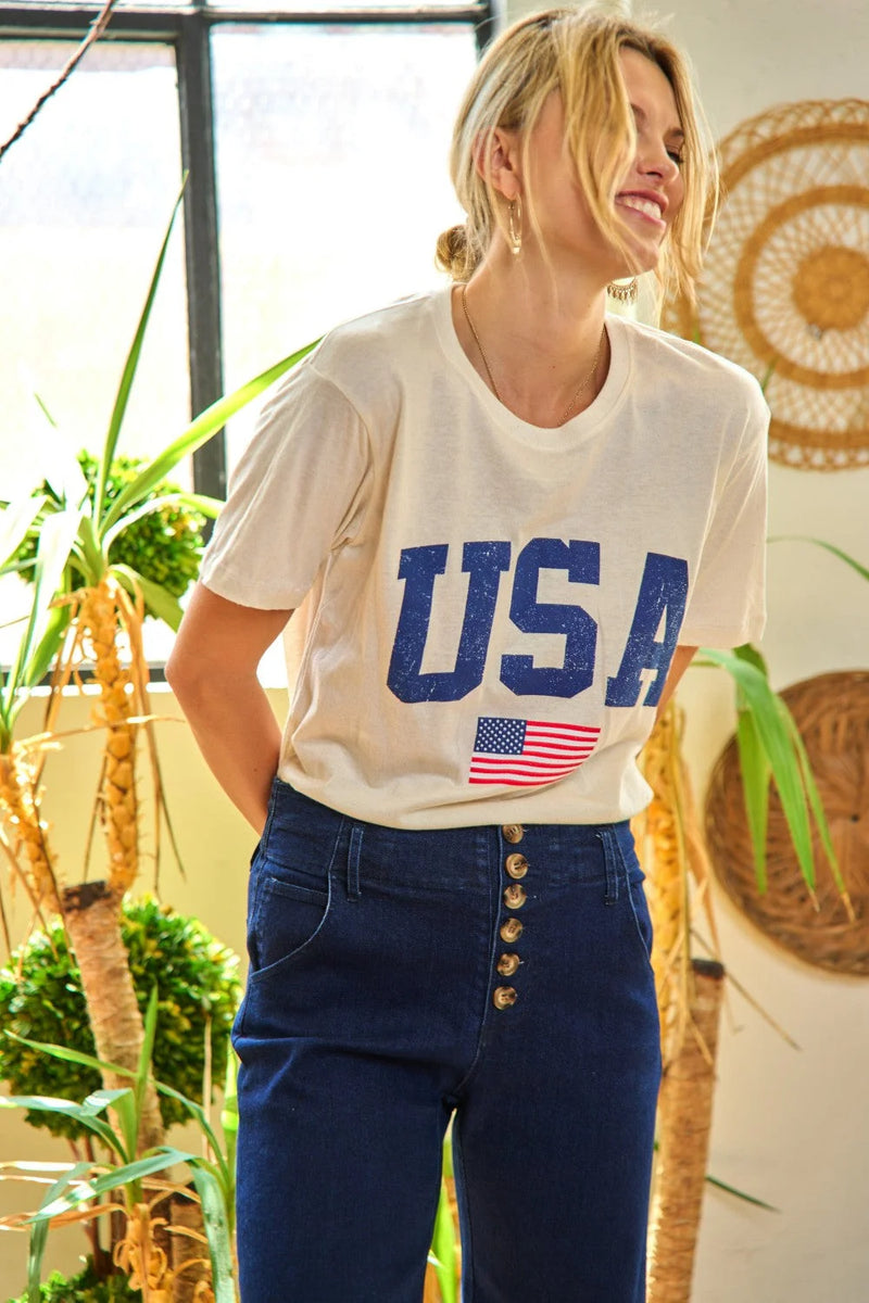 Woman in USA T-shirt and jeans showcasing stylish short sleeve graphic print