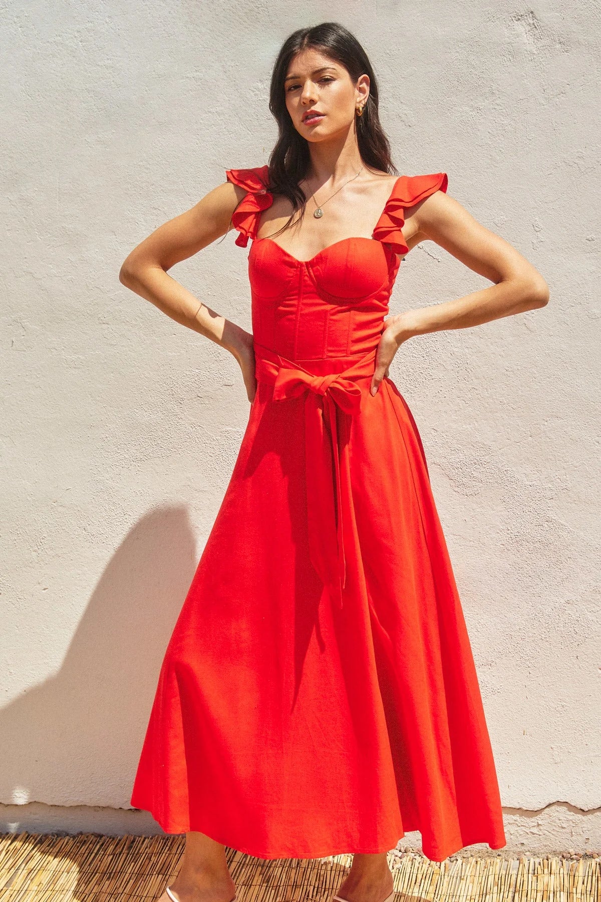 Woman modeling HEAVEN SENT CORSET FLUTTER DRESS with ruffled shoulder straps and tie waist