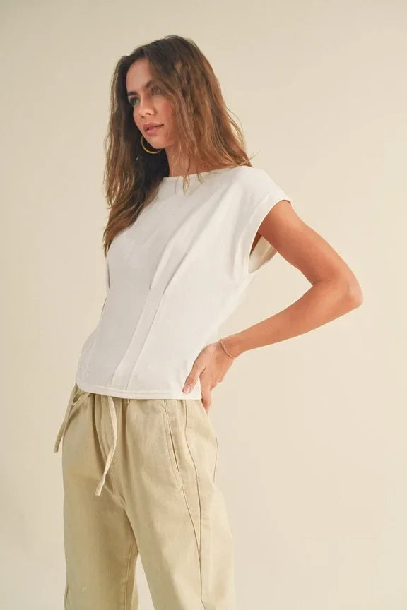 Woman in white top and beige pants showcasing Corset Style Body Top against a plain background