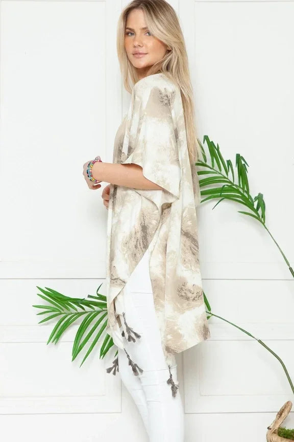 Woman in Mellow Melanie Marble Print Kimono with palm fronds in the foreground