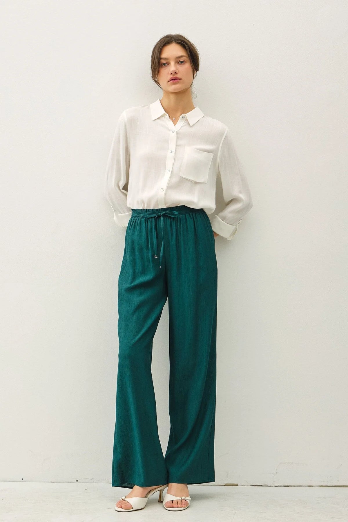 Woman wearing crinkle wide leg pants with elastic drawstring waist in boho chic style