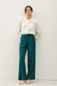 Woman wearing crinkle wide leg pants with elastic drawstring waist in boho chic style