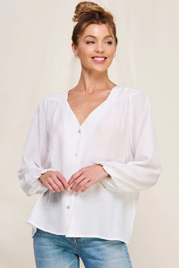 Woman in a white blouse and jeans featuring a Flowy Button Front Shirt for a boho look