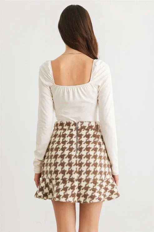 Woman in white top and brown houndstooth skirt showcasing Bone Cowl Neck long sleeve bodysuit