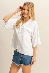 Woman in white linen boho chic top paired with denim skirt, ideal for shop Daisy fashion