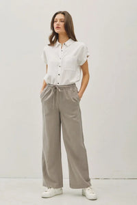 Woman wearing stylish gray wide-leg pants with pockets, ideal for women’s boho chic clothing at Shop Daisy