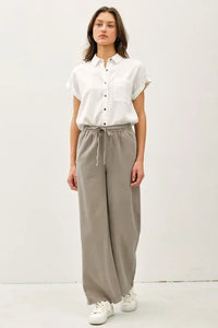 Women’s boho chic clothing featuring wide leg pants with pockets and elastic waist