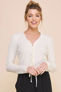 Smiling woman in a crinkled woven lace-up top from Shop Daisy’s women’s boho chic clothing