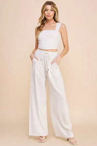 Woman in white crop top showcasing Striped Linen Smock Waist Pants for a stylish look