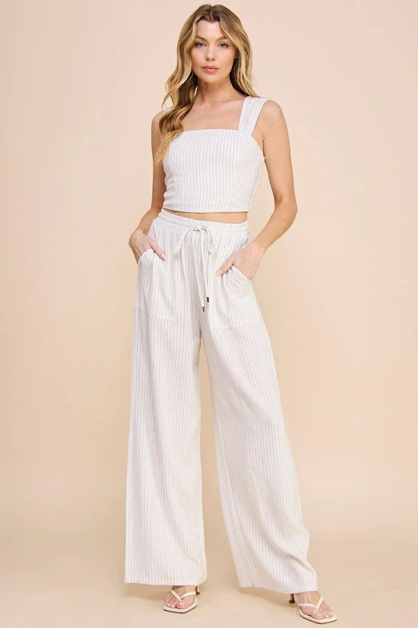 Woman in white crop top showcasing Striped Linen Smock Waist Pants for a stylish look