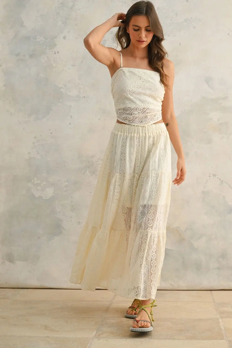 Woman wearing a white crochet lace tiered two-piece outfit, showcasing a lace skirt in BOHO ME style