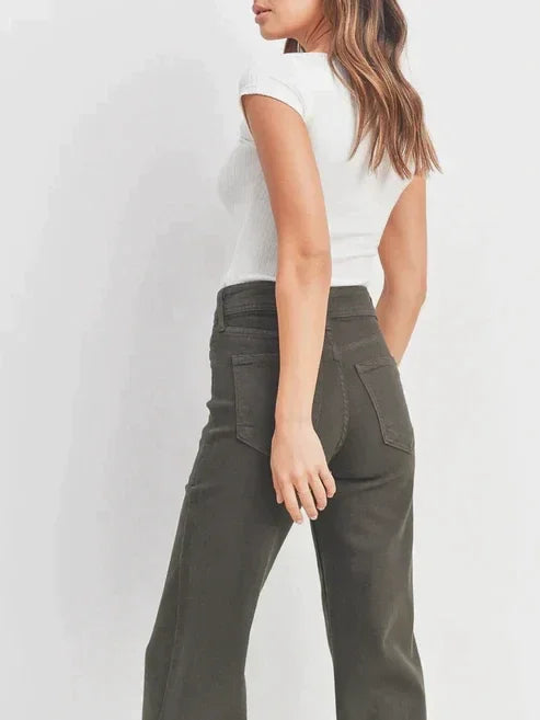 Woman in a white top and green pants wearing Nautical Wide Leg Denim in washed black