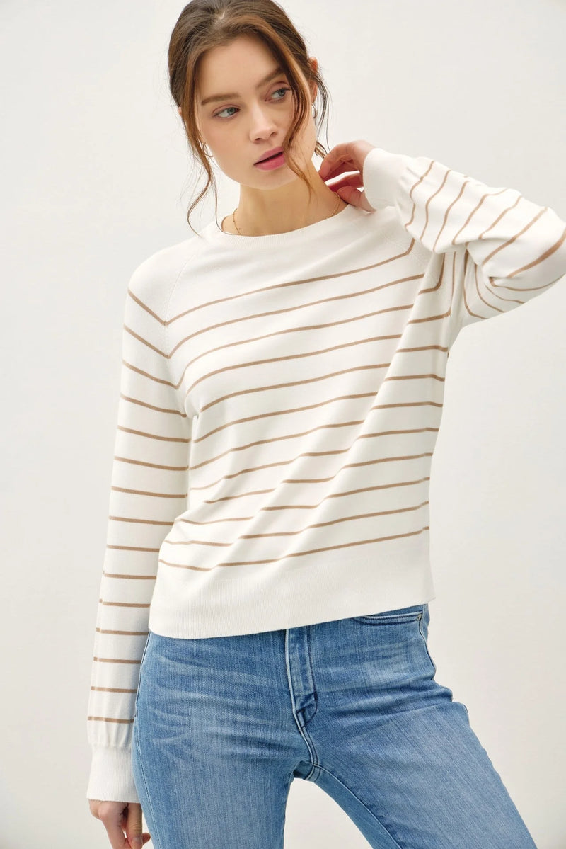 Woman wearing lightweight striped long long sleeve sweater with white and brown stripes