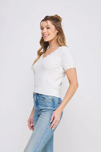Woman wearing a white Pointelle V-Neck Knit Top with scallop edges, boho chic clothing style