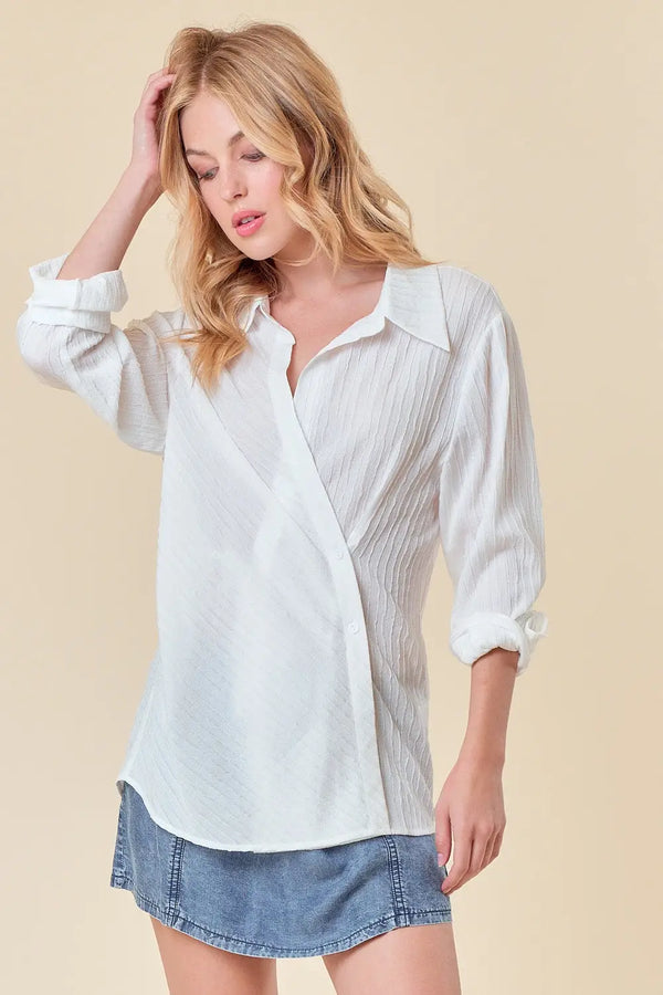 Woman in a white shirt and denim shorts wearing a Textured Point Collar Wrap Top
