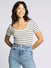 Woman wearing a white striped Katara Tee with light-wash jeans, part of Supply Katara collection