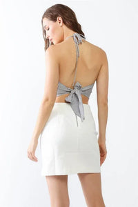 Woman in white skirt and striped halter top, perfect for a boho free spirit look