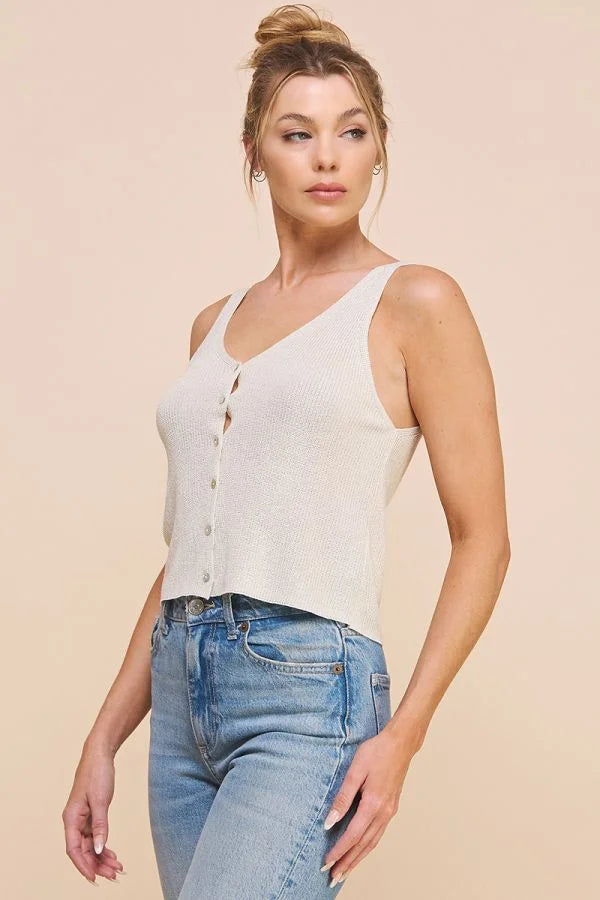 Woman in a white sleeveless top and blue jeans showcasing a Lightweight Sweater Knit Button Front Tank