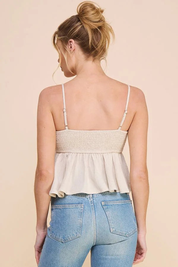 Woman in white sleeveless cami tank babydoll and blue jeans, seen from behind