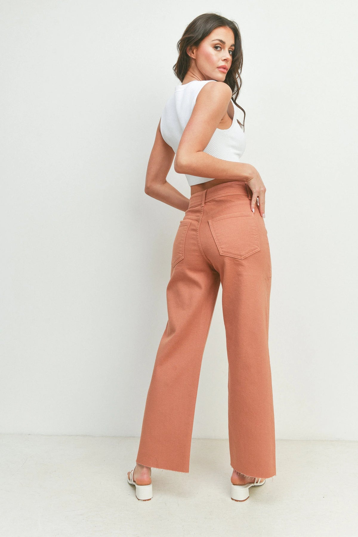 Woman in white sleeveless top and peach wide leg trousers from Nautical Wide Leg collection