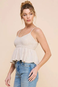 Woman in white spaghetti-strap cami tank babydoll with blue jeans