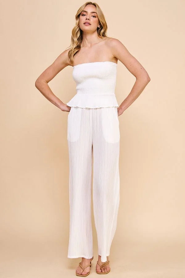 Woman in a white strapless jumpsuit paired with Textured Woven Adjustable Tie Waist Pants