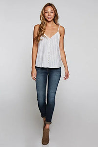 Woman modeling white striped camisole with dark wash skinny jeans and brown ankle boots for women’s boho chic clothing at Shop Daisy