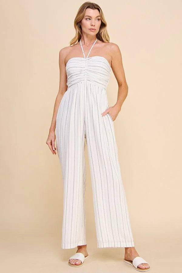 Woman modeling a white striped Spaghetti Halter-Tie Ruched Lined Jumpsuit