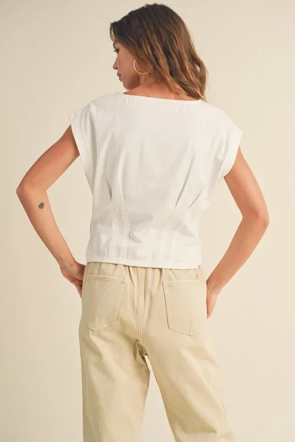 Woman in white t-shirt and beige pants showcasing Corset Style Body Top from behind