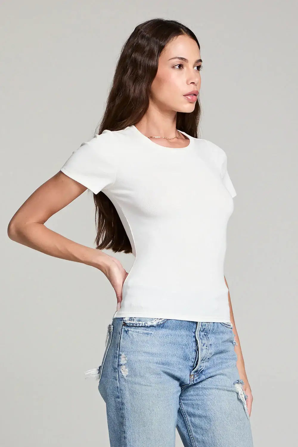 Woman in white crew neck tee and blue jeans from Shop Daisy’s women’s boho chic clothing