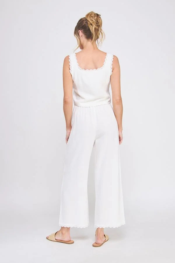 Woman in white linen blend lace up tie front tank top with wide-leg pants