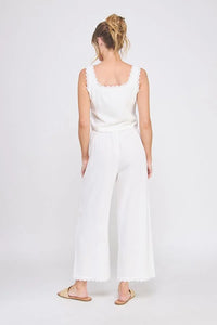Woman in white linen blend lace up tie front tank top with wide-leg pants