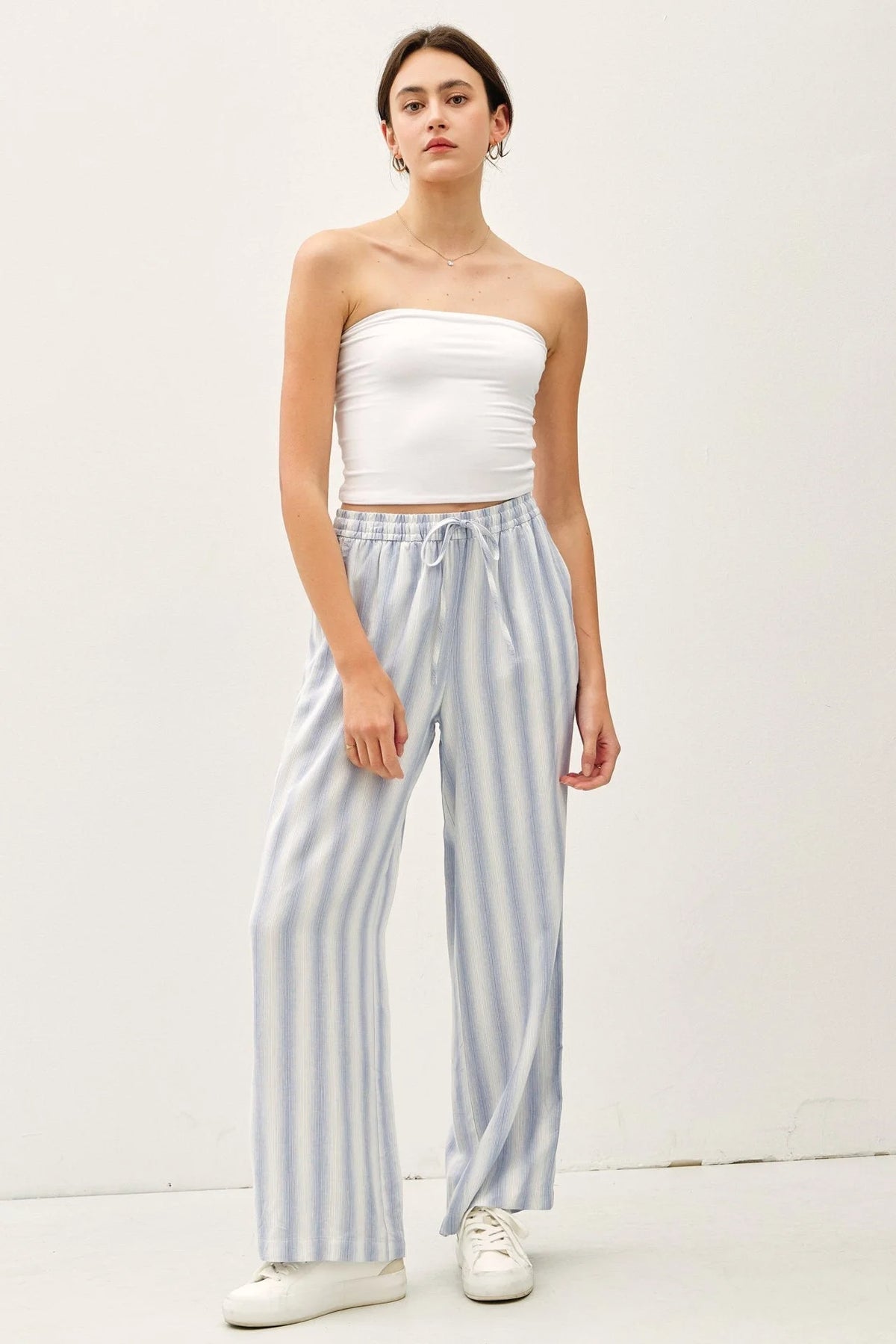 Woman wearing ombre striped wide-leg trousers with a drawstring waist