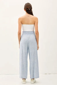 Woman wearing striped linen-rayon wide leg pants with elastic waistband and white tube top