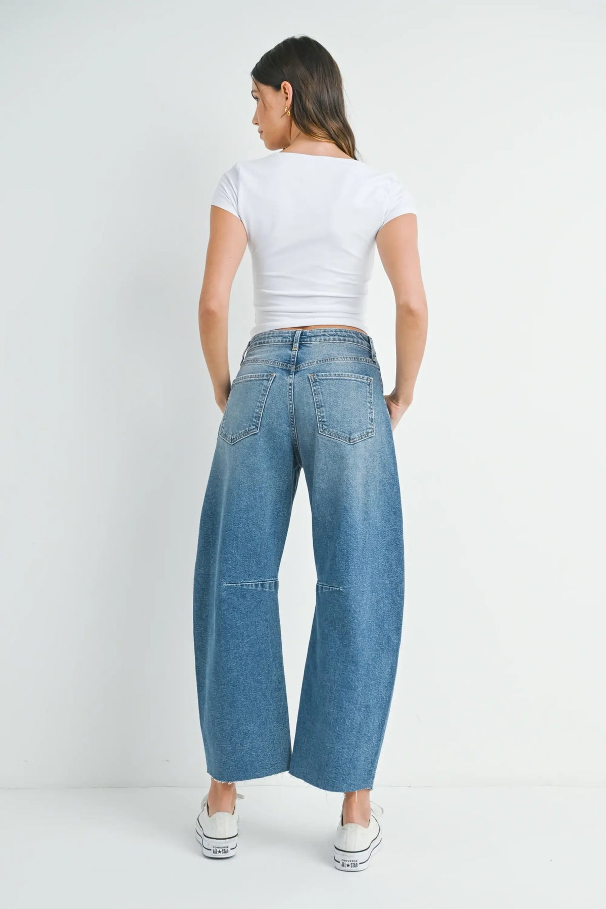 Woman in wide leg denim showcasing THE SEAMED BARREL WILD LEG BLACK WASH JEANS