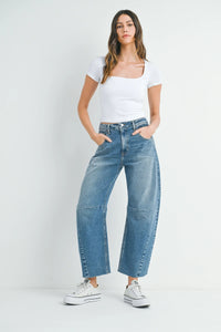 Woman wearing THE SEAMED BARREL WILD LEG DENIM JEANS in stylish wide leg black wash