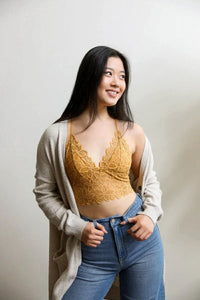 Woman in a yellow racerback flower lace bralette padded with stylish jeans outfit