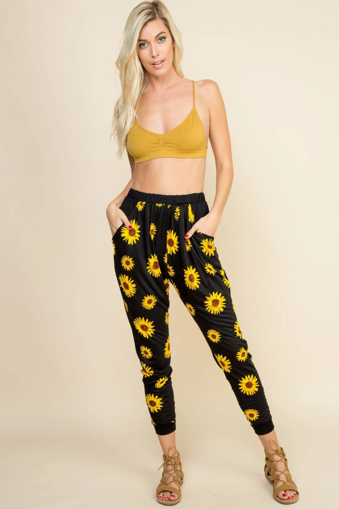 Woman in yellow crop top and black pants showcasing a stylish mustard bralette