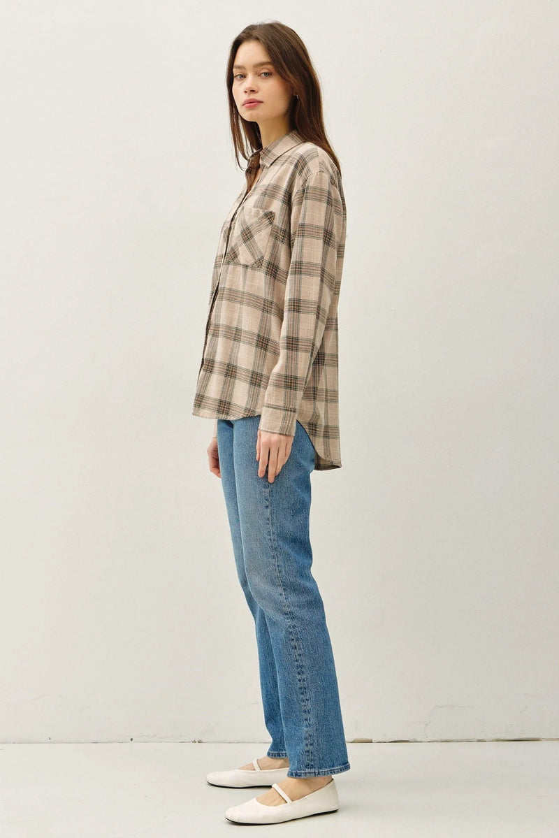 Woman wearing classic cotton small plaid shirt in beige and brown tones
