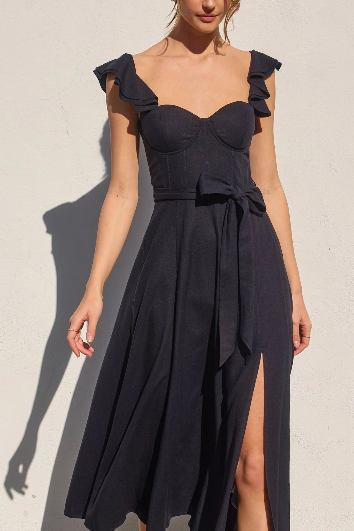 Black corset flutter dress with sweetheart neckline, ruffled cap sleeves, and side slit