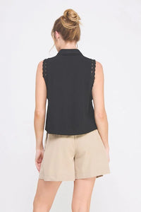 Woman wearing a black pintuck sleeveless collared shirt with lace trims by Daisy Lane