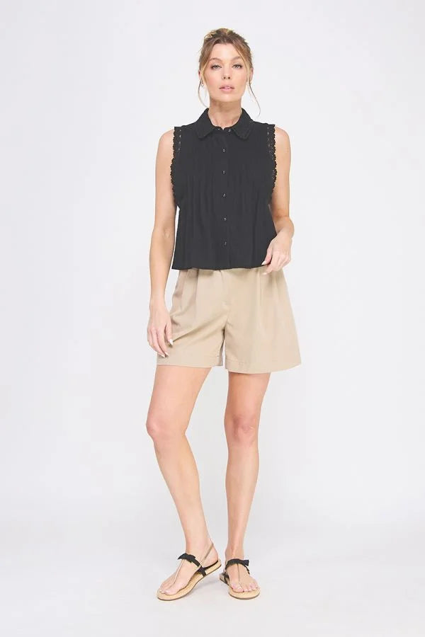 Woman wearing PINTUCK SLEEVELESS COLLARED SHIRT WITH LACE TRIMS and khaki shorts at Daisy Lane