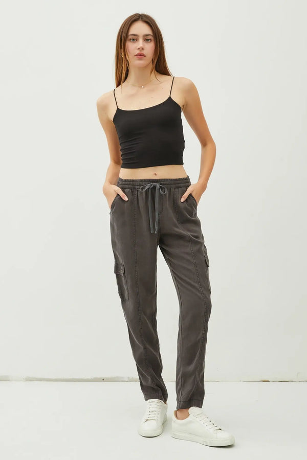 Woman wearing black spaghetti strap crop top and TENCEL Cargo Utility Pants