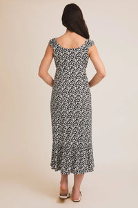 Woman’s black and white floral print midi dress with tie cap sleeves and ruffled hem