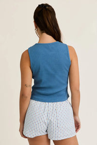 Woman wearing blue rib tank top and striped shorts from Shop Daisy Lane